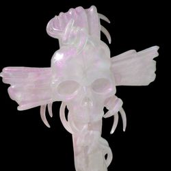 Ethereal pink-colored resin skull and cross