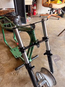 Frame with wheels handle bars and clutch with motor.