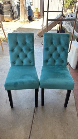Two turquoise dining chairs