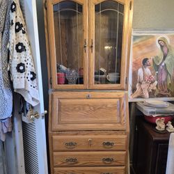 antique oak secretary desk featuring a drop-front writing surface, display hutch, and multiple drawers. 