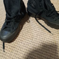 Black Converse high tops .
