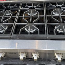 This appliance is a 36-inch Wolf gas rangetop featuring six burners and stainless steel construction