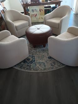 Four swivel chairs one ottoman one rug conversation pit