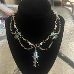 handmade blue and gold beaded necklace with jellyfish charm