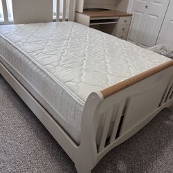 Full size white and wood bed with mattress, spring box and with the matching study desk.