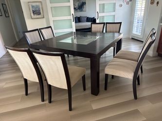 Modern dinning table with 8 chairs and two table clothes custom made.