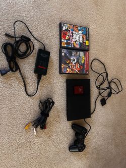 PlayStation 2 slim. Cables, controller, card. And 2 games