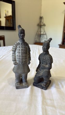 Two modern ceramic replicas of Qin Dynasty Terracotta Army soldiers.