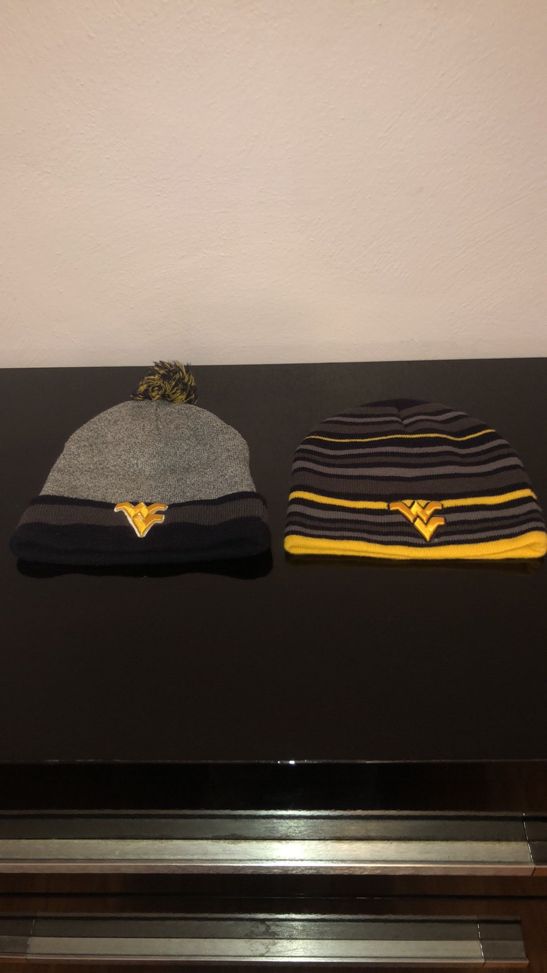 Two ONE SIZE FITS ALL West Virginia toboggans. Like new!