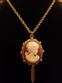 $20. Vintage Cameo goldplate tassle locket necklace with faux pearls. Necklace is 24-in. Pendant including tassel is 3.5 in long and 1.5 in wide.
