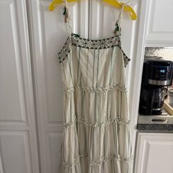 The Ranna Gill for Anthropologie Safa Tiered Shimmer Midi Dress features a tiered silhouette with metallic striped