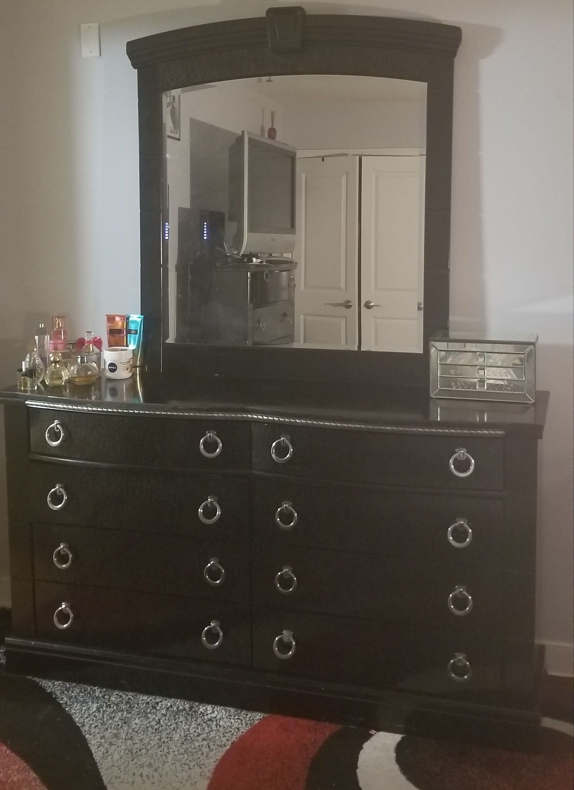 Ashley dresser with mirror and 5 dresser drawer. Will have items delivered to you for an additional cost. Plus, if you like the area rug it's free!