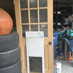 Dog Door Electric  And Door Is Like New still has the plastic on the glass