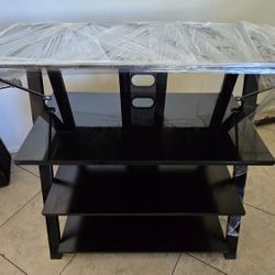 FOUR-TIERED TEMPERED GLASS BLACK AND CHROME TV OR MEDIA STAND.