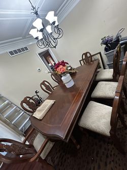 Hardwood dining table, chairs(8), and plate set(8)