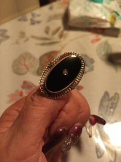 Vintage 10 karat gold black onyx ring knuckle to knuckle what time in accent in the middle size 7. can easily be sized up or down beautiful ring.