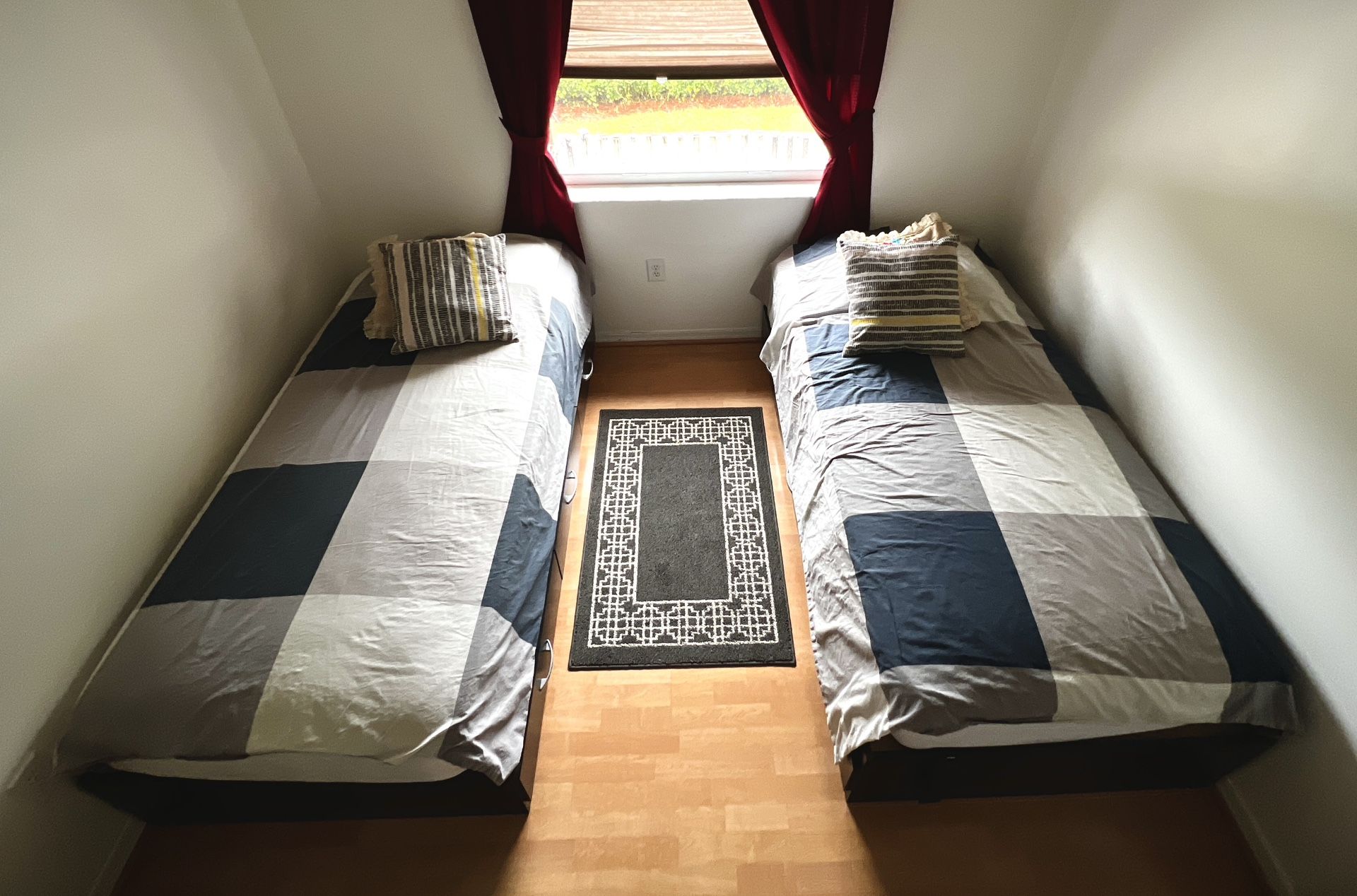 Two (2) Twin beds frames with three storage draws each and two mattresses twin size.