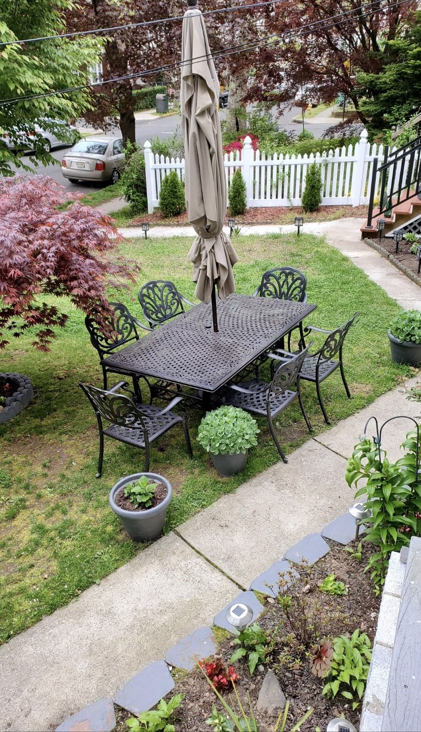 Cast Aluminum table With Six Chairs , Umbrella and Base included.