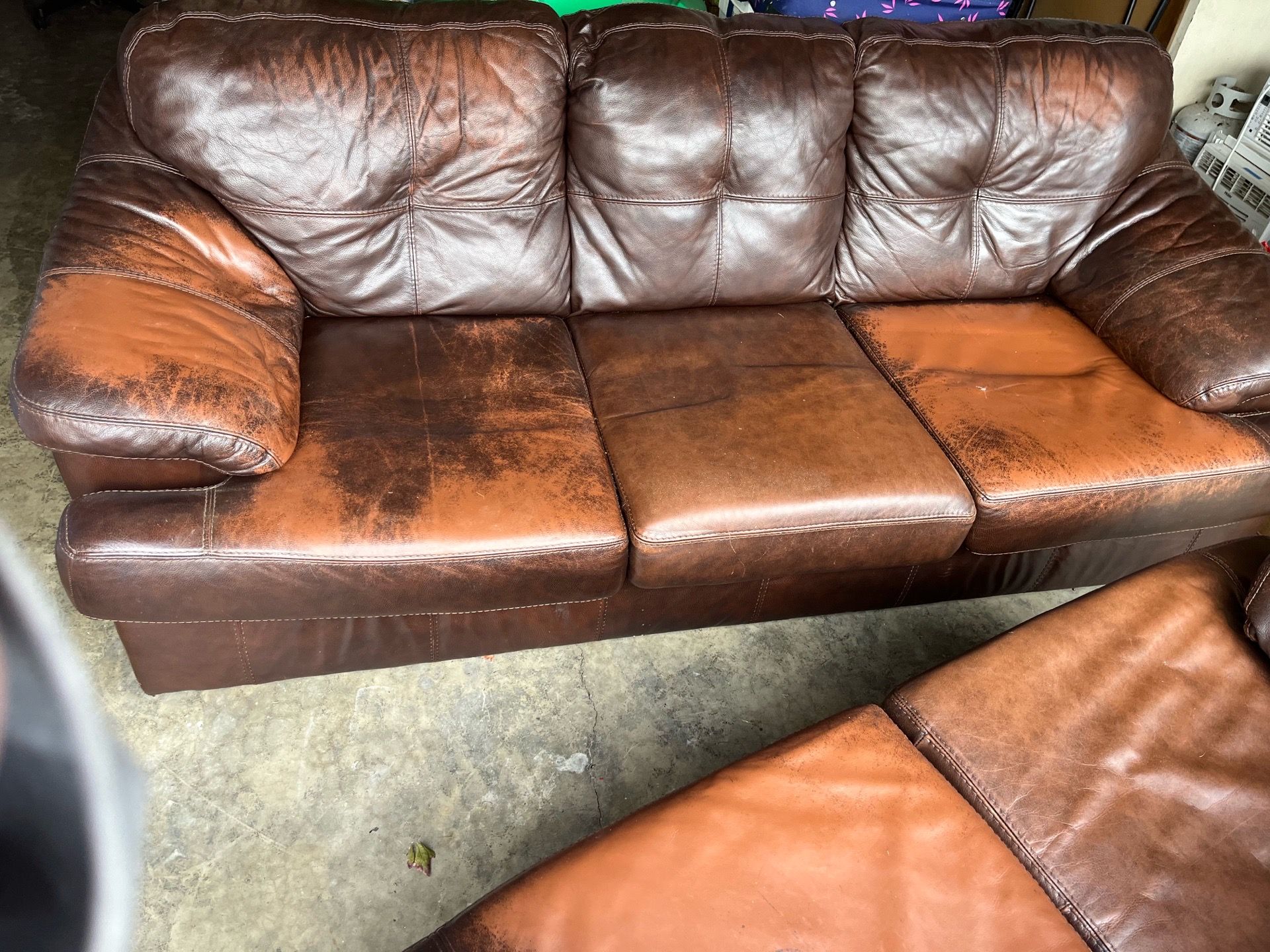 Brown leather couch and love seat
