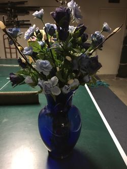 Blue flowers in blue glass vase