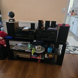 Stereo System With Amp, Cassette Player And Recorder  , DVD And Cd Player, Speakers And This TV Stand.