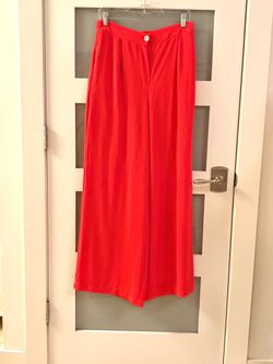Lemaler bright red palazzo pants feature a high waist and a wide, flowing silhouette. L