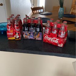 18 bottles Coca-Cola Classics maybe 15 to 20 years old possibly