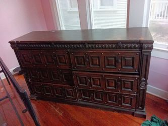antique Jacobean-style oak chest features intricate geometric paneling typical of the late 17th century.