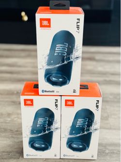 New JBL Flip 7 portable speaker in original box. This blue waterproof speaker has Bluetooth v5.4 and 16-hour battery life. It is a compact cylindrical