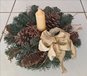 Nice holiday table centerpiece artificial pine greenery with pine cones, gold‑trim bow and candle. Measures 12 inches diameter, 7 inches tall. Great f