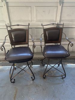 A Pair of Wrought Iron Bar Stools