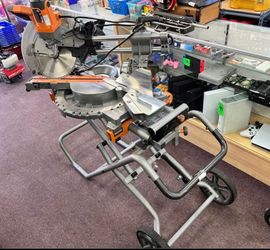 RIDGID 12 in. Dual Bevel Sliding Miter Saw whit a mobile stand.