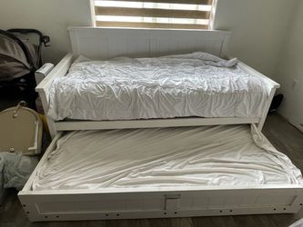 Twin bed with bed frame and a twin pull out