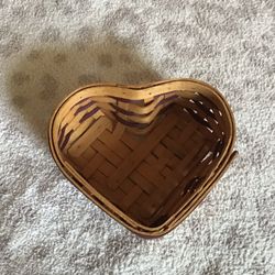 Longaberger 2000 Century Celebration heart shaped basket 6.25 inches long, 5.25 inches wide, and 2.5 inches tall. The top part of the lid is worn and 
