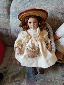 Doll in wicker chair.