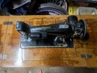 Vintage 1950 singer sewing machine on fold out table with original bench