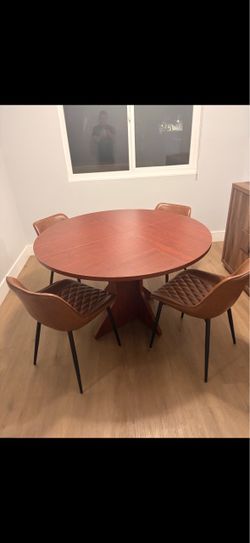 Round wooden dining table with 4 chairs