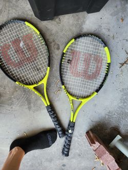Tennis Rackets And Couple Softball Bats