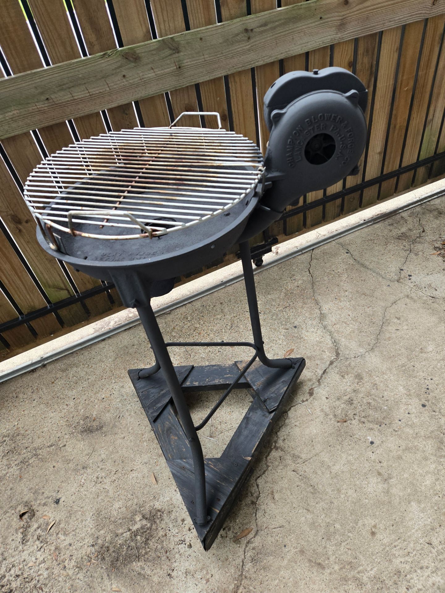Vintage BBQ grill with hand crank blower.