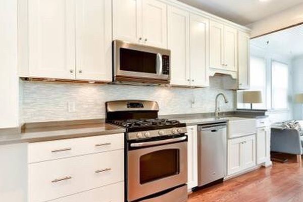 Tall White Kitchen Cabinets , Quartz Countertop , Moen Faucet