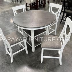 5-Piece Counter Height Dining Set–Round counter height table with chairs. Includes table and chairs, perfect for casual dining. Features grey chairs 