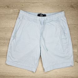 The product is a pair of Boys Hollister XS Blue Shorts. These athletic shorts are made of cotton and are machine washable, making them perfect for act