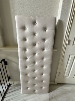 Cream colored tufted upholstered headboard