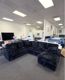Black corduroy sleeper sofa with bed and storage chaise