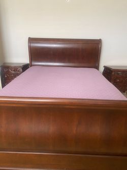 Sleigh bed and ornate carved night stands