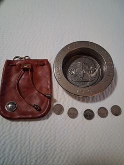 Five buffalo nickels,one, collectible buffalo plate, and one leather buffalo pouch
