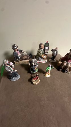 collection of vintage porcelain hobo clown figurines, including pieces resembling Emmett Kelly Jr. and Waco Melody in Motion musical hobo clown statue