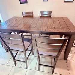 Living space sturdy brown table and upholstered counter height chairs