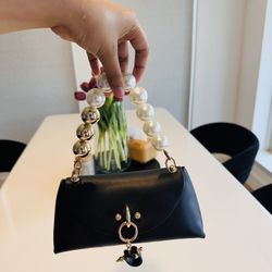 Elegant black handbag with pearl handle