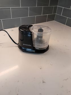 Proctor Silex 1.5-Cup Food Chopper featuring a clear plastic work bowl and lid.